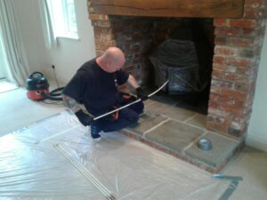 Photo of our operative sweeping a chimney